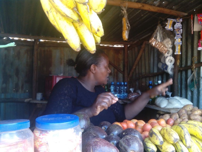 Sabina in her grocery store narrating her experience